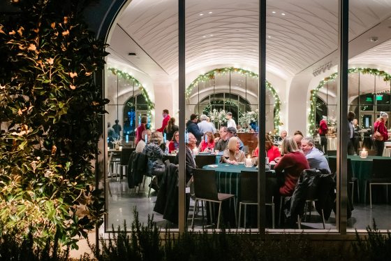 People dining at seated tables inside The Fountain Room at Longwood. 